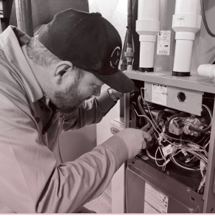 True Quality HVAC technician performing a furnace repair in Crown Point, IN.