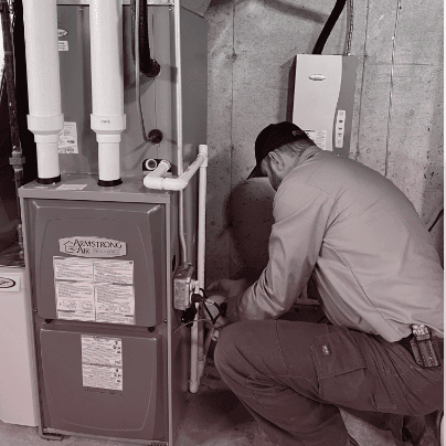 True Quality HVAC technician installing a new Armstrong Air furnace in Saint John, Indiana, home.