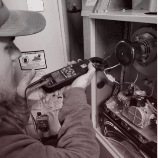True Quality HVAC technician performing maintenance on a furnace in Cedar Lake, Indiana.